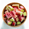 Wooden bowl filled with red and green striped candy on a white background