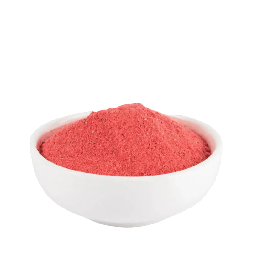 White bowl filled with red powder on a white background