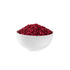 White bowl filled with red powder on a white background