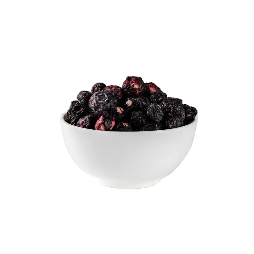 White bowl filled with dried blackberries on a white background
