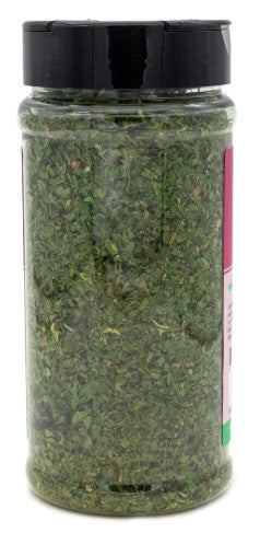 Jar of green spice with a black lid on a white background
