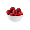 White bowl filled with red strawberries on a light gray background
