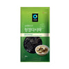 Green package of Dolsim brand kelp with a bowl of soup on a white background